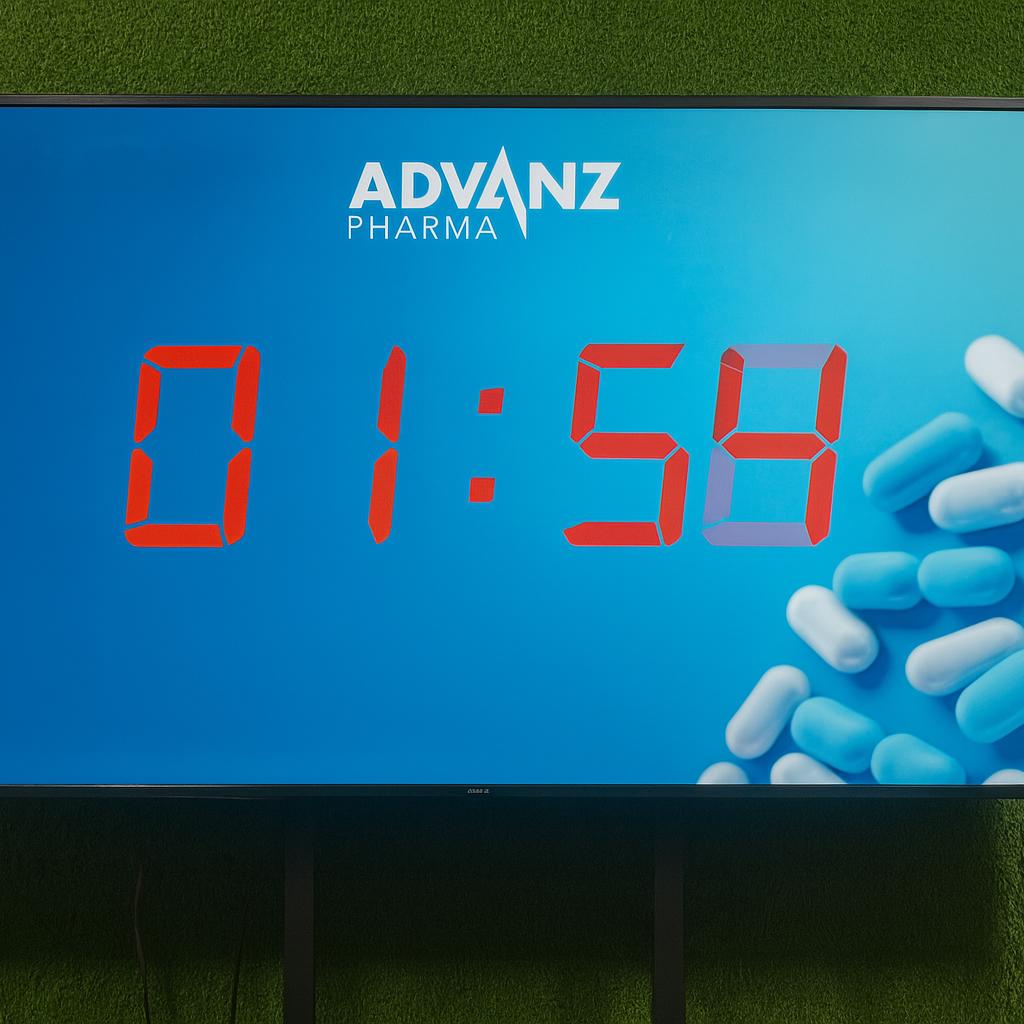 Guests playing Stop the Time interactive stopwatch game at a corporate event booth in Dubai, engaging with branded screen and trying to press the button at the perfect moment